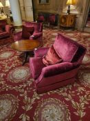 A pair of upholstered armchairs, upholstered in a deep reddish-crushed velvet fabric Each armchair