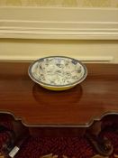 A Chinoiserie-style blue and white decoration of birds and flora on its white interior, contrasted
