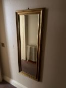 Rectangular Dress Mirror with Gold-Finished Frame A vertically oriented rectangular dress mirror
