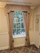 A pair of traditionally styled drapes with a coordinating shaped pelmet and decorative rope tie-