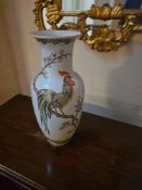 A porcelain vase. The ovoid body features a subtly flared rim and a tapered foot, all covered in a