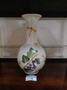 A baluster-form porcelain vase with a globular body and a flared neck, adorned with polychrome