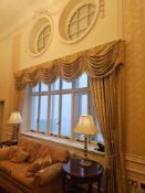An elaborate set of traditional window drapes, comprising a heavily draped valance with intricate