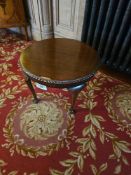 A Chippendale Style Round Mahogany Side Table, featuring a plain circular top with a decorative