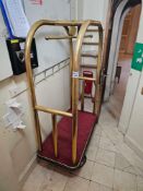 A brass-toned 'birdcage style' hotel bellhop luggage cart. This classic hotel-style trolley features