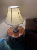 A Chinese porcelain table lamp with hand-painted botanical and avian motifs. The cream-colored