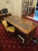 An English partner's desk, mahogany. The rectangular top features three inset leather panels. One