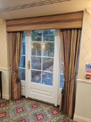 A pair custom-made set of drapes features a fabric pelmet with full-length curtain panels, crafted