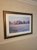 A large, rectangular print, depicting a landscape in an impressionistic style with soft, muted tones