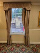 A pair of traditionally styled drapes with a coordinating shaped pelmet and decorative rope tie-