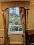 A pair of traditionally styled drapes with a coordinating shaped pelmet and decorative rope tie-
