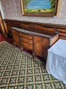 A large and ornate wooden sideboard displaying a revival style from the late 19th or early 20th