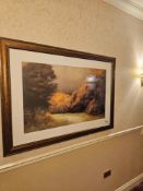 A large, framed landscape print attributed to Megan Lightell depicting an atmospheric natural
