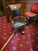 An executive-style swivel office captains chair, constructed with a dark-stained wooden frame