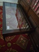A Maxine Snider style Coffee Table a dark-stained wooden frame with a clear glass tempered top and