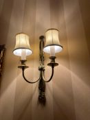 Pair of brass double-arm wall sconces with fabric shades and classical revival detailing. Each