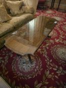 A Neo-classical revival style rectangular coffee featuring a clear glass protective top set over a