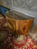 A Neoclassical-style demilune cabinet, attributed to Baker Furniture, crafted from veneered wood