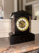A Victorian mantel clock featuring a pediment-top architectural case. The primary construction is