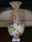 A baluster-form porcelain vase with a globular body and a flared neck, adorned with polychrome