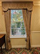 A pair of traditionally styled drapes with a coordinating shaped pelmet and decorative rope tie-