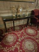 An English Regency style mahogany console table The frieze is adorned with carved fluting, rosettes,
