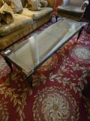 Empire revival style rectangular coffee table features a dark-stained wood frame, accented with gilt