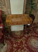 A late regency style burr walnut dressing table, featuring a rectangular top and a single drawer,