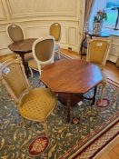 Table and a pair of chairs the octagonal table in walnut, features a central turned pedestal base