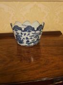 A Blue Willow style ceramic cachepot with a distinctive scalloped rim, decorated in a classic blue