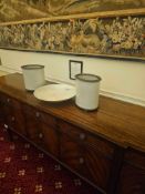 A pair of oval-shaped planters or cachepots crafted from white ceramic, featuring pervasive