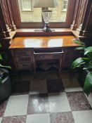 A mahogany kneehole desk exhibiting a traditional Georgian or early Victorian-inspired style. It