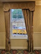 A pair of traditionally styled drapes with a coordinating shaped pelmet and decorative rope tie-