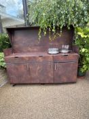 Outdoor bar or serving unit, possibly made of Corten steel or a similar The unit features a hinged