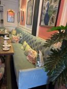 A chesterfield style sofa upholstered the back rest tufted and raised on splayed legs 250 x 70 x