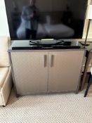 Two door cabinet embossed facia panel doors open to reveal internally fitted cubby space, drawers