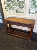 A rustic, dark wood console or accent table featuring a rectangular top and a lower slatted shelf
