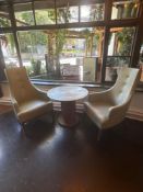 A pair of contemporary arm chairs and coffee table the armchairs upholstered in a faux cream leather