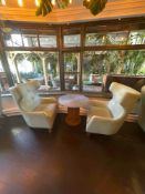 A pair of contemporary wing back arm chairs and coffee table the armchairs upholstered in a faux