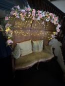 A Louis XVI bergere carved cane sofa a two-seater bergère, resembling a small loveseat or settee,