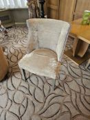 An upholstered side chair the shaped back with pin trim detail upholstered in two tone contract