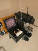 Nespresso Pod machine A compact capsule-based espresso machine in matte black with ribbed