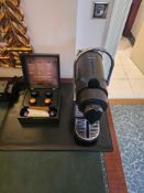 Nespresso Pod machine A compact capsule-based espresso machine in matte black with ribbed