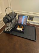 Nespresso Pod machine A compact capsule-based espresso machine in matte black with ribbed