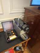 Nespresso Pod machine A compact capsule-based espresso machine in matte black with ribbed