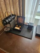 Nespresso Pod machine A compact capsule-based espresso machine in matte black with ribbed