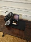Nespresso Pod machine A compact capsule-based espresso machine in matte black with ribbed