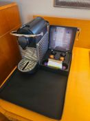 Nespresso Pod machine A compact capsule-based espresso machine in matte black with ribbed