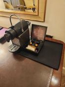 Nespresso Pod machine A compact capsule-based espresso machine in matte black with ribbed