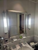 A rectangular mirror presented in a silver painted frame with subtle decorative engraving, The frame
